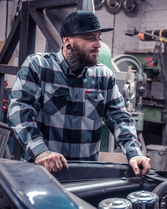 the banger black gray and red flannel front view on a man fixing up his classic car