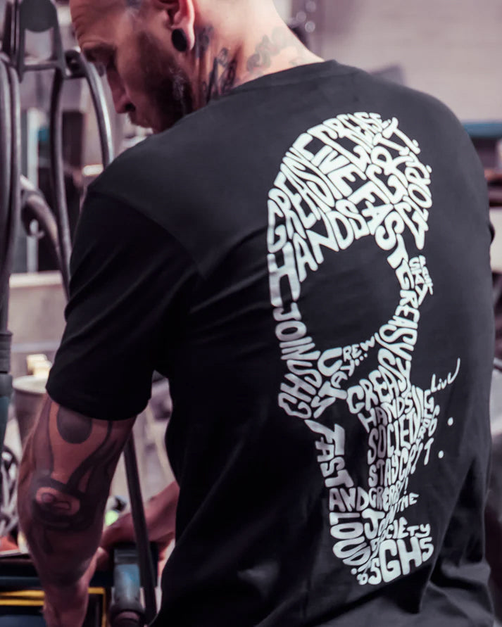 way of life black t-shirt on a model with the words live fast stay greasy in a skull shape