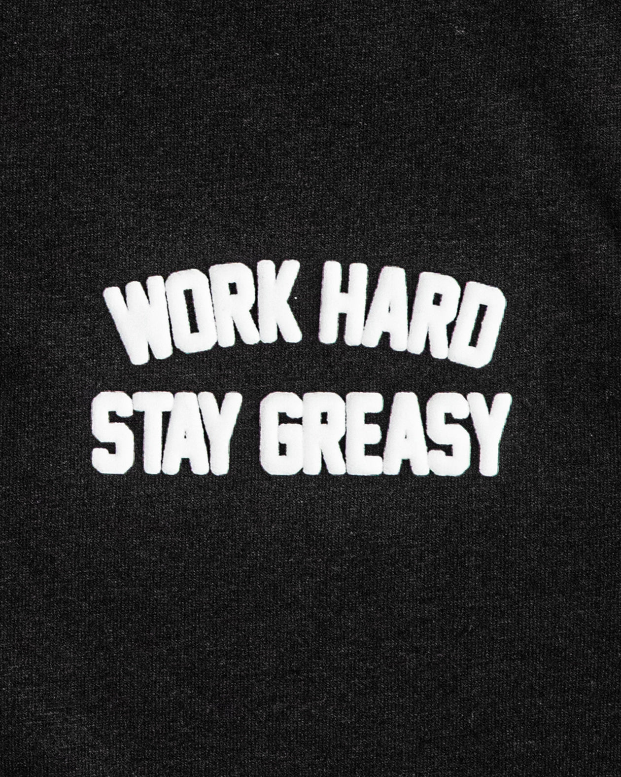 Black women's crop top with 'Work Hard Stay Greasy' text in white on a black background