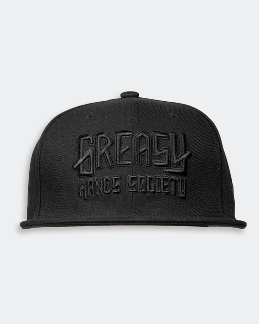 Black cap with black 'Greasy Hands Society' logo on a light gray background