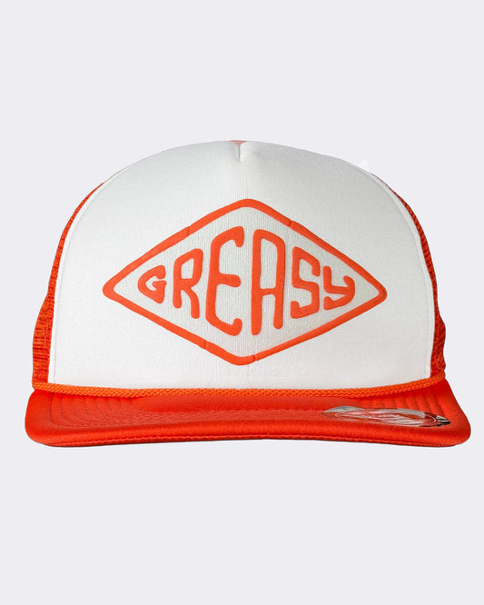 A white and orange trucker hat featuring a large orange diamond logo with the word 'GREASY' on the front panel, set against a light gray background - Cross the Line Orange/White Hat by Greasy Hands Society