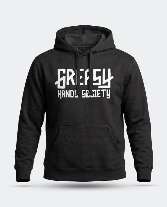 A black pullover hoodie with a white graphic print of the Greasy Hands Society logo on the chest reading 'GREASY HAND SOCIETY' in a stylized font, shown against a light gray background - The GHS Logo Hoodie by Greasy Hands Society