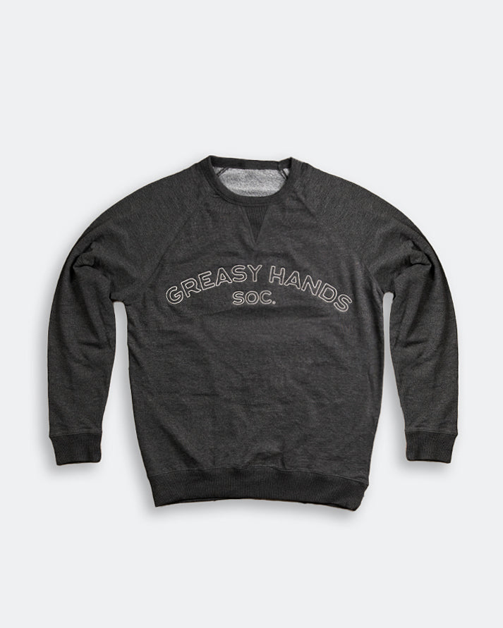 Dark gray sweatshirt with 'Greasy Hands Soc' text on a light gray background