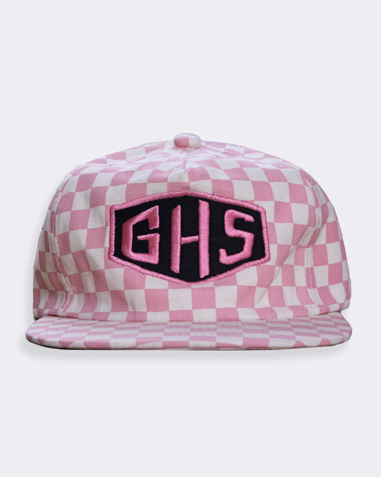 Pink checkered cap with 'GHS' logo on a white background greasy hands society's momentum pink sheckerboard hat