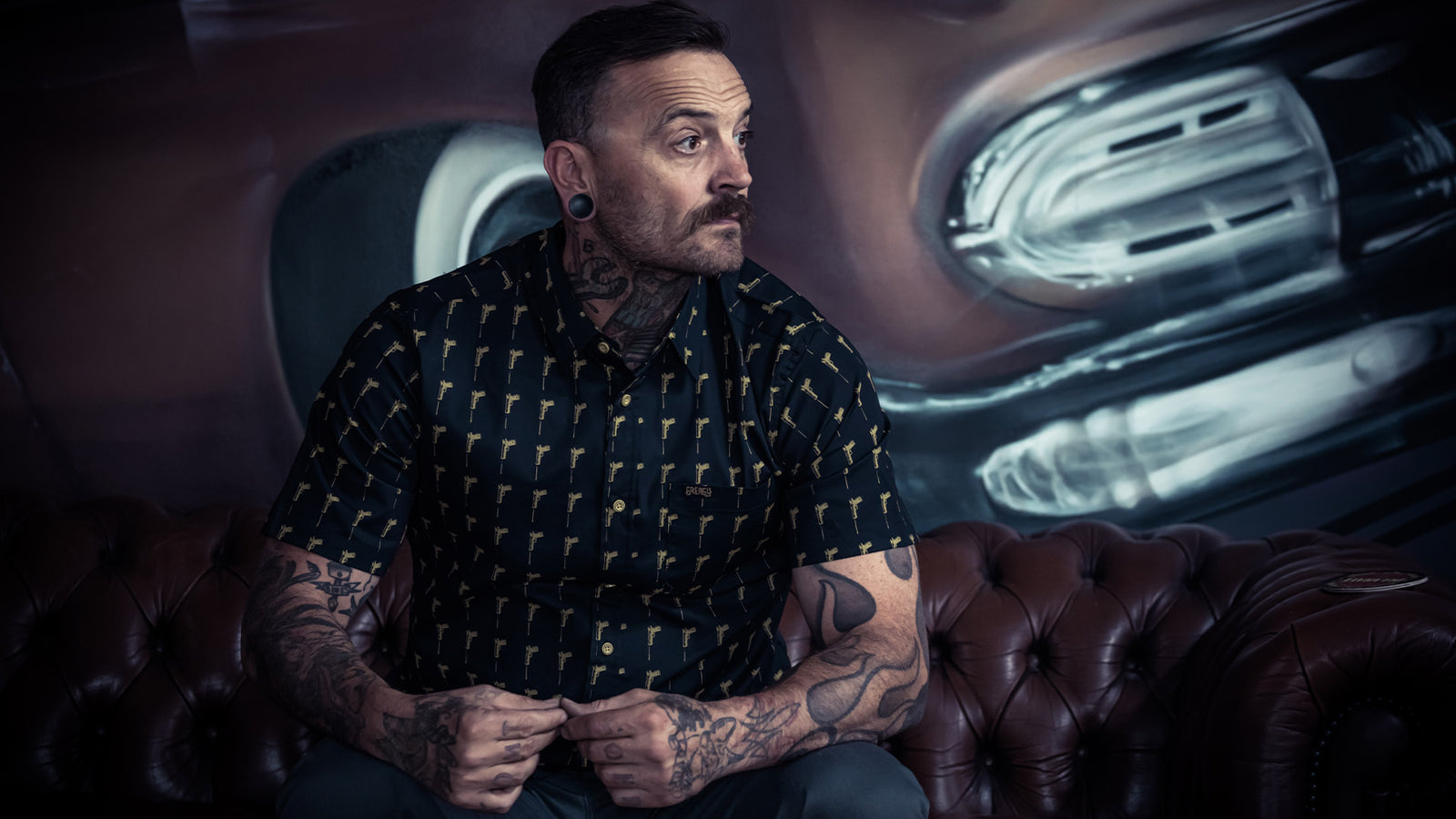 hitman button up short sleeved shirt with a golden gun pattern