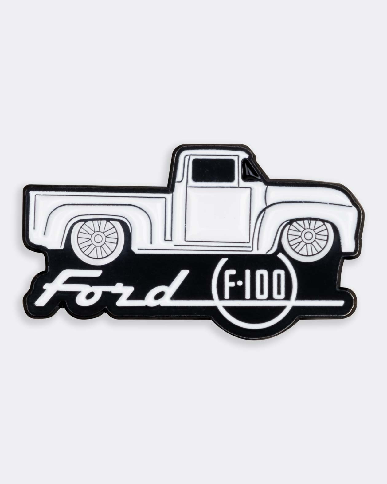 ford f-100 truck enamel pin in black and white on a gray background