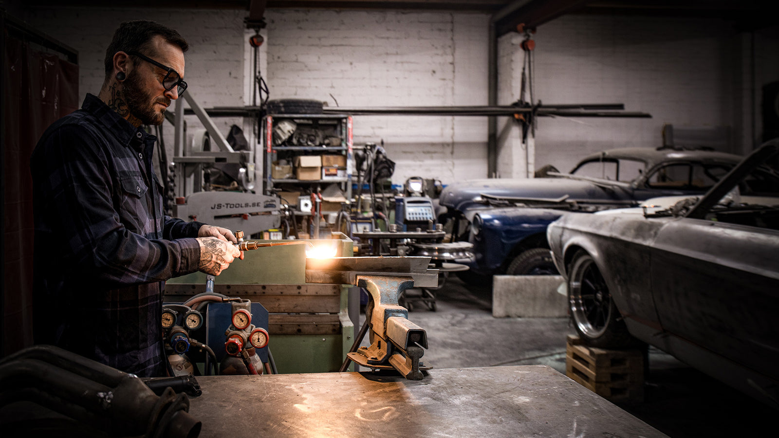 synister black flannel worn by a welder working on his car