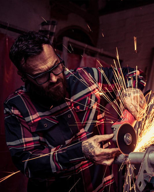 devil in the details black and red flannel being worn while grinding - work flannel