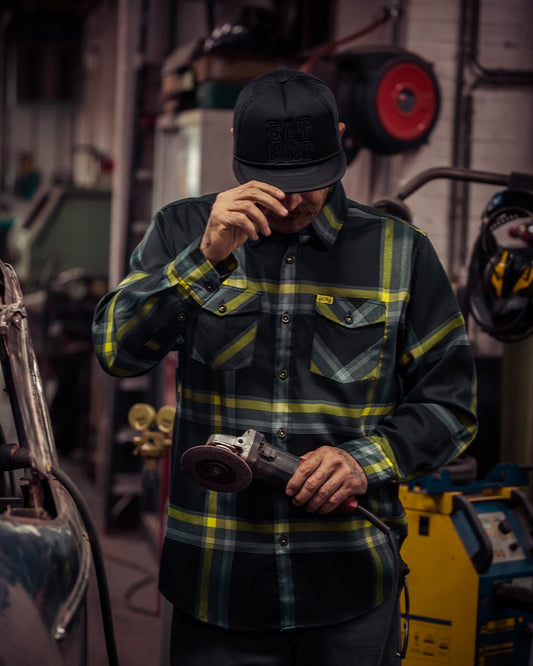 eat dust flannel on a model black yellow and gray flannel