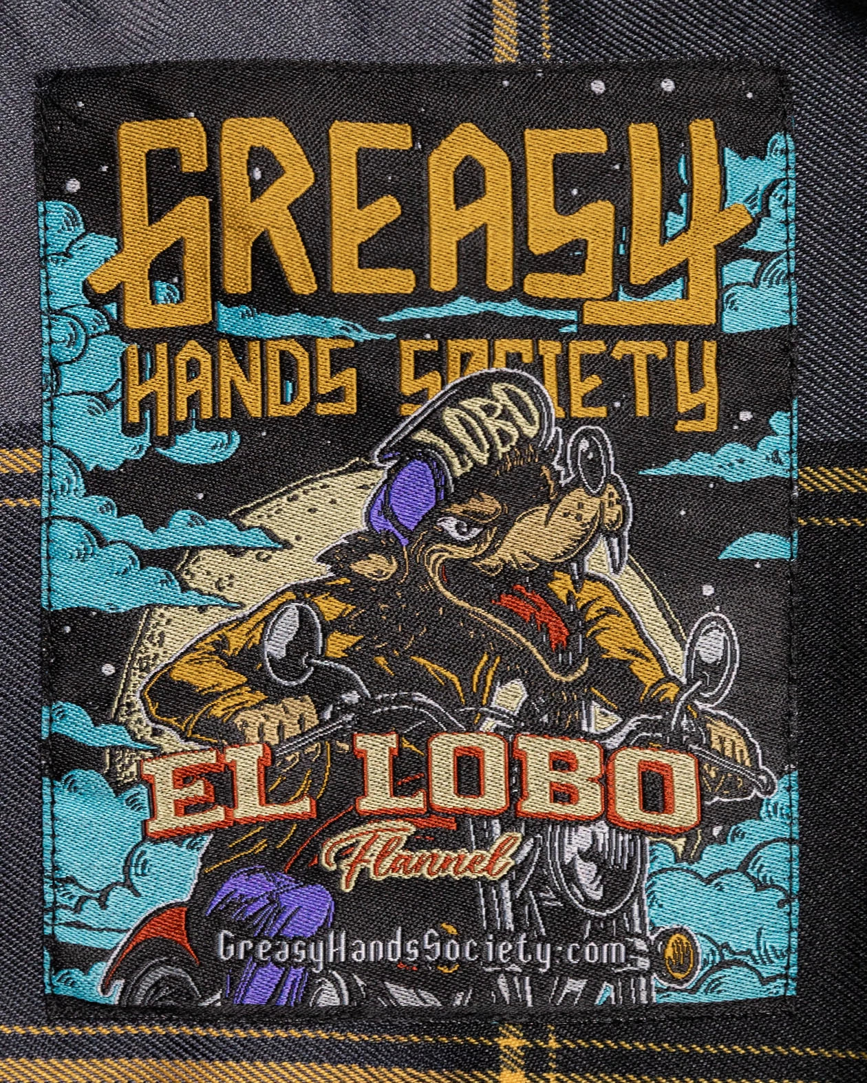 el lobo flannel tag detail art showing a wolf on a motorcycle - El Lobo Flannel by Greasy Hands Society