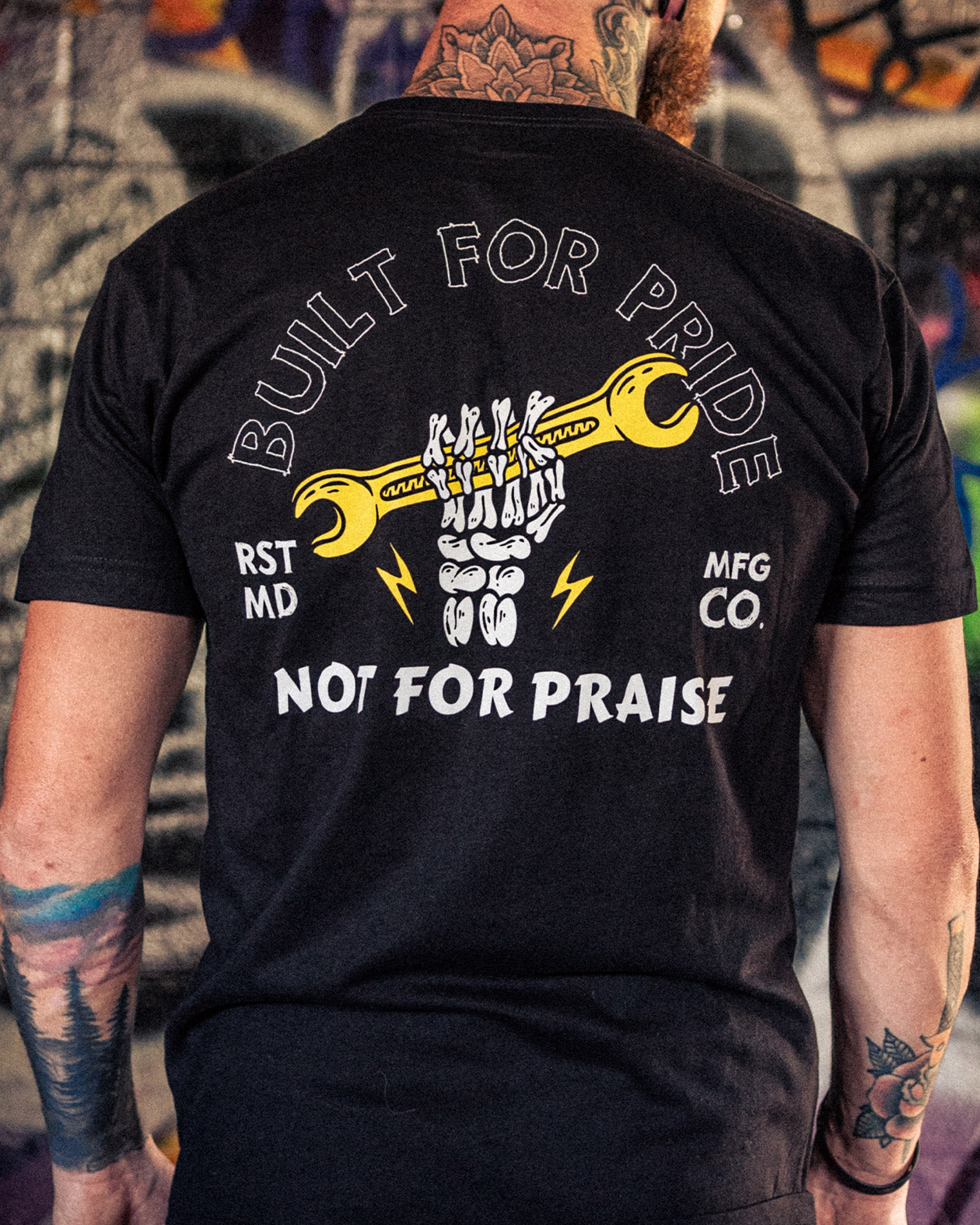 built for pride black graphic t-shirt showing a skull hand raising a wrench