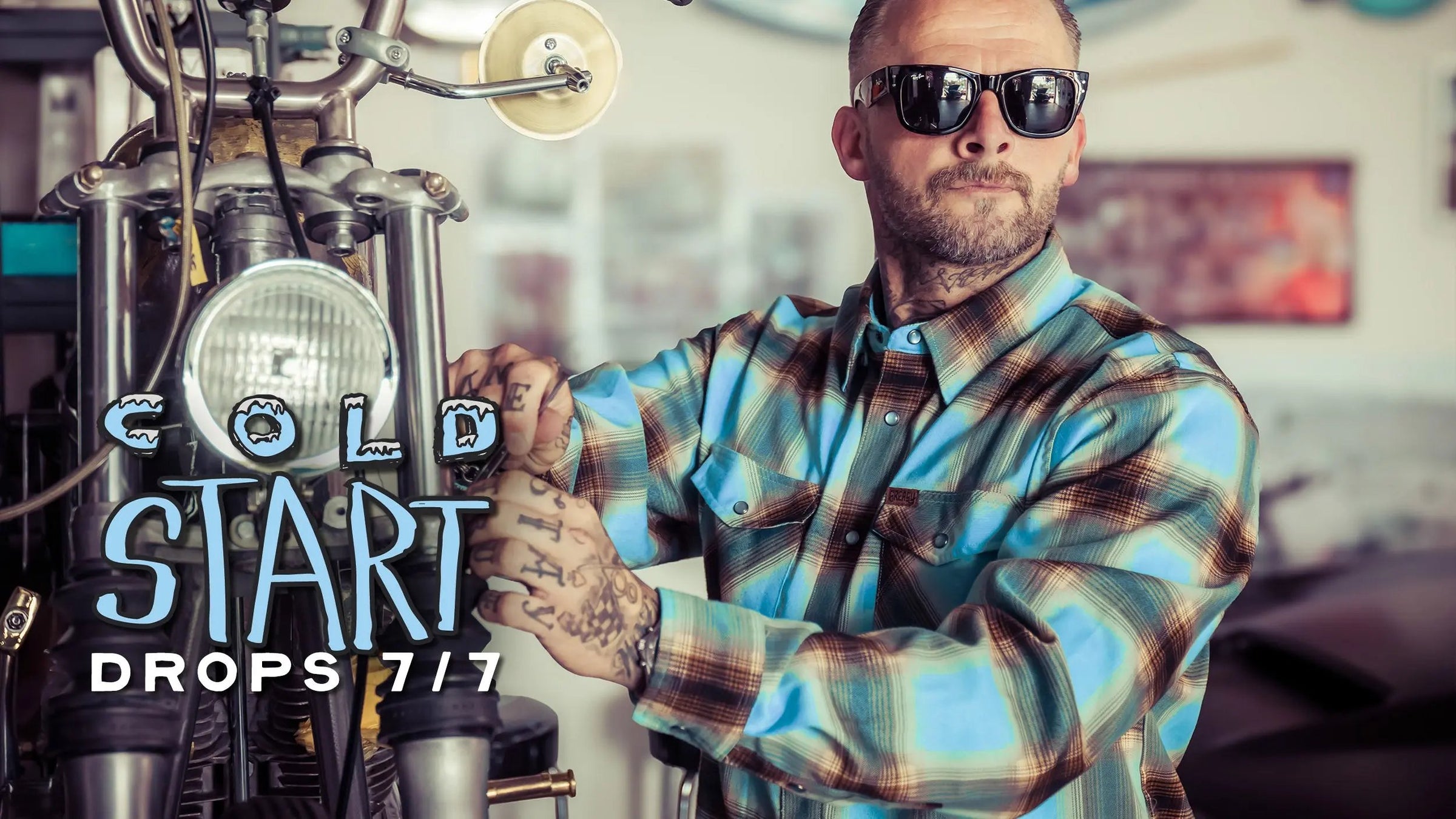 Man in plaid shirt and sunglasses operating a coffee machine with 'Cold Start Drops 7/7' text.