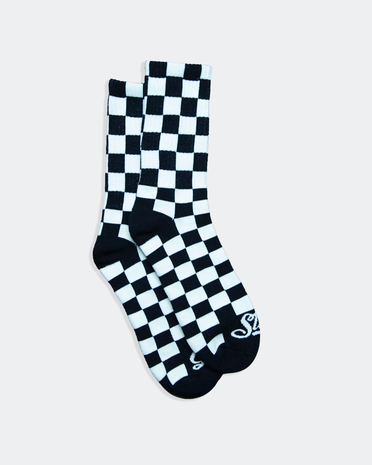 Black and white checkered sock on a light gray background from greasy hands society