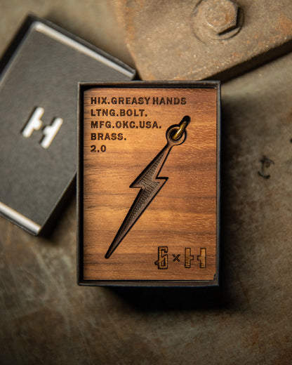 brass lightning bolt pendant in the wood box it will be shipped in