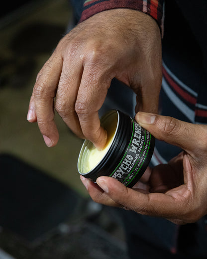 psycho wrench oil & grit oil-based pomade being used for a pompador