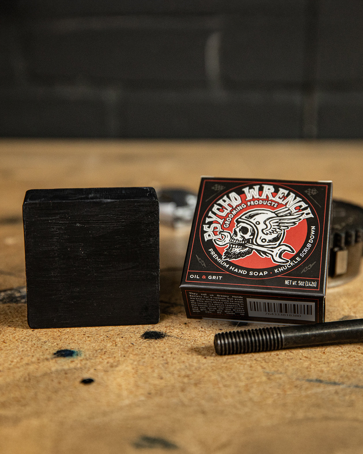 psycho wrench oil & grit bar soap showing the soap in the package on a worktop - by greasy hands society - knuckle down bar soap