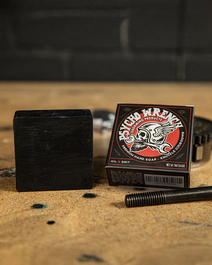 psycho wrench oil & grit bar soap showing the soap in the package on a worktop - by greasy hands society - knuckle down bar soap
