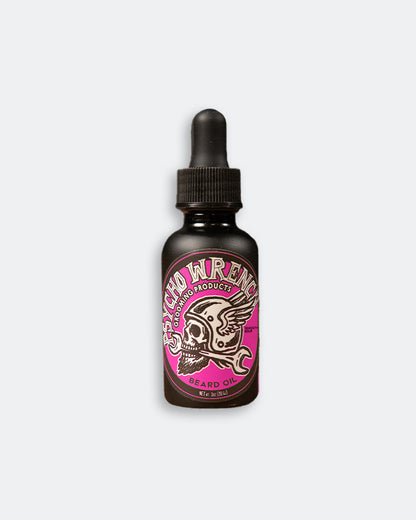 Bottle of Psycho Wrench beard oil with a pink label on a white background