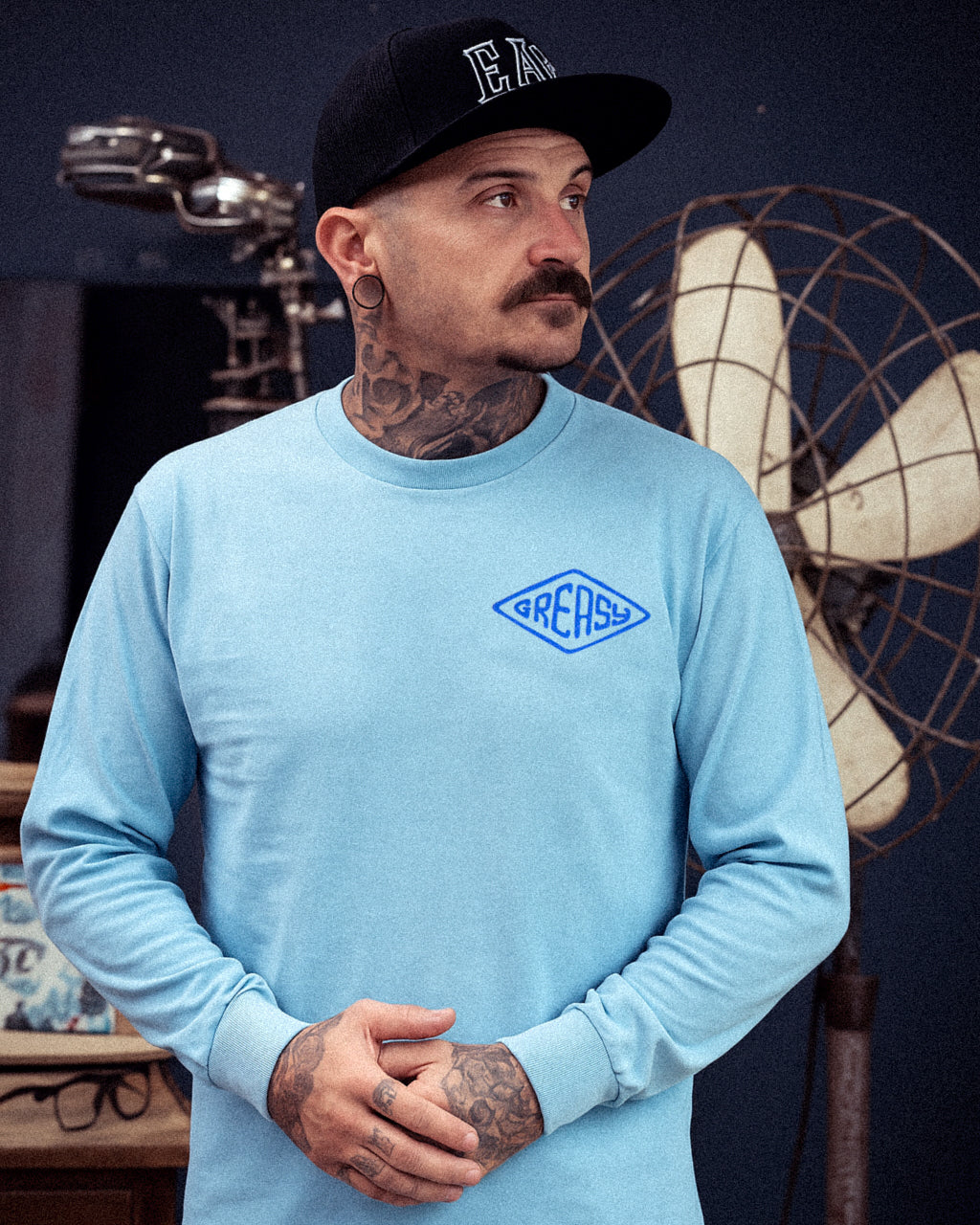 cross the line sky-blue long sleeved t-shirt with greasy in a diamond on the left chest