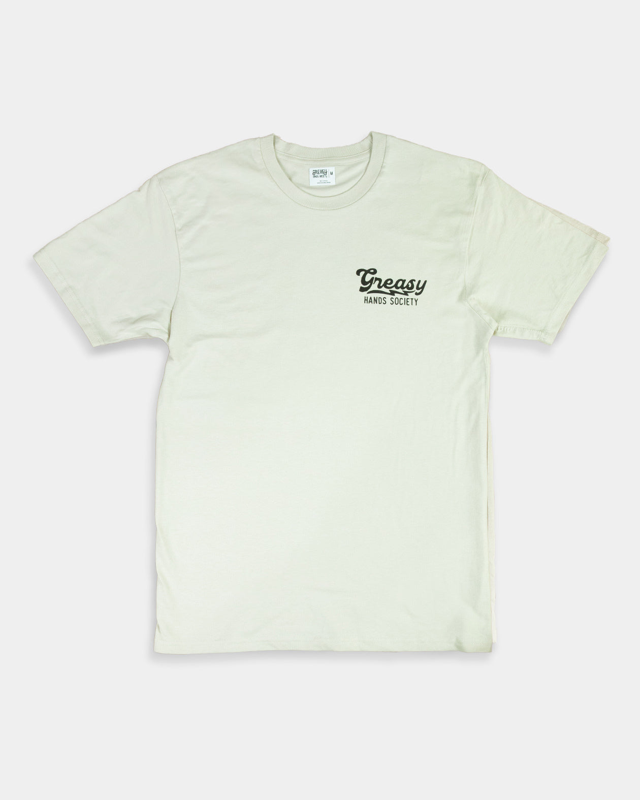 Light beige women's graphic tee t-shirt with 'Greasy' logo on a white background showing the front side with left chest graphic