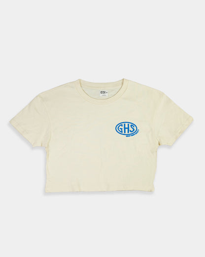 Beige crop top t-shirt with a blue logo on a white background -  Buckle Up Crop Top by Greasy Hands Society