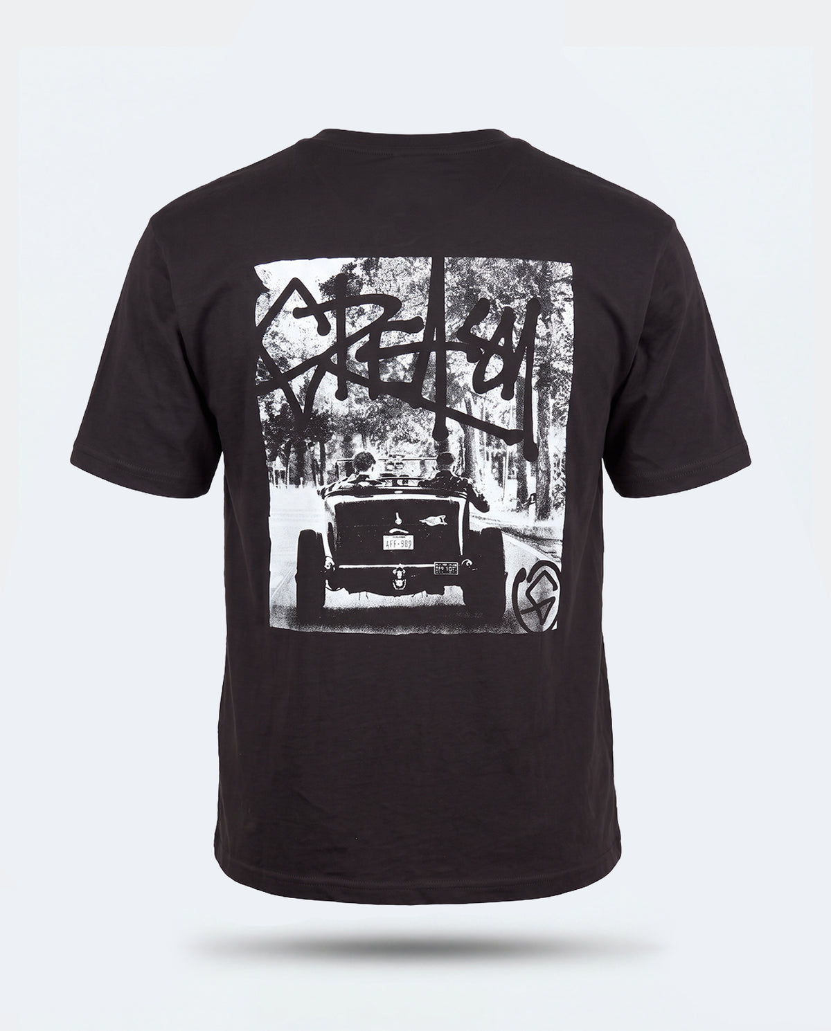 A black short-sleeve t-shirt shown from the back, featuring a large white graphic print of a vintage hot rod car in a forest with graffiti-style lettering - Detroit Steel Graphic Tee by Greasy Hands Society