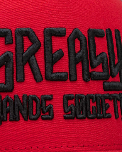 black greasy hands society logo on red hat detail