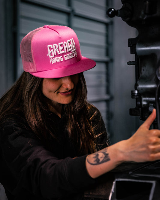 pink greasy hands society with white logo trucker hat for women