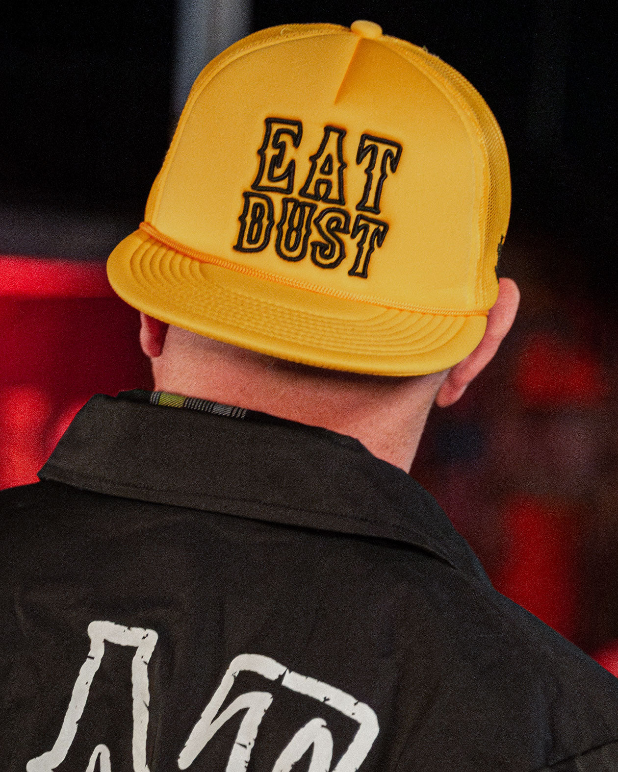 gold eat dust hat with black text