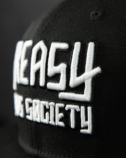 detail shot of a black cap with white greasy hands society logo on the front - showing the stitching