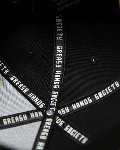 interior of a Black cap with white text on a dark background