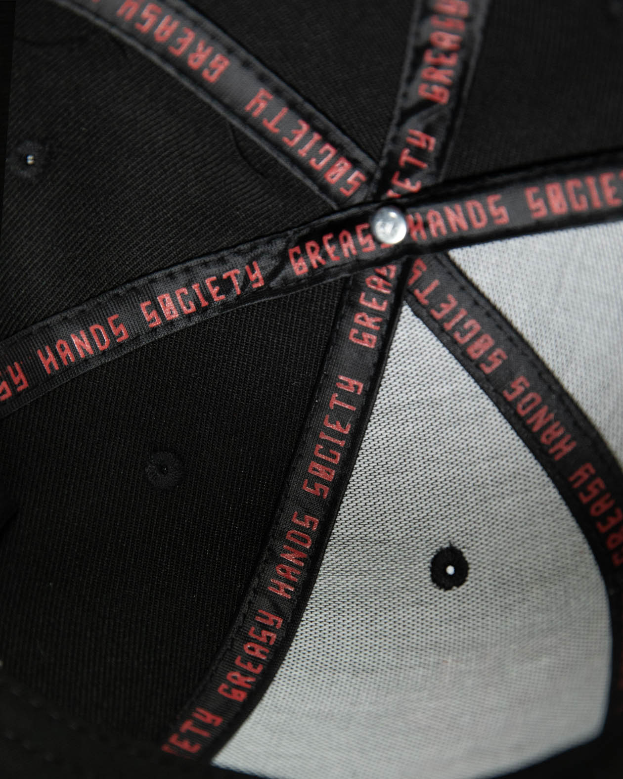 interior of a Black cap with red text on a dark background