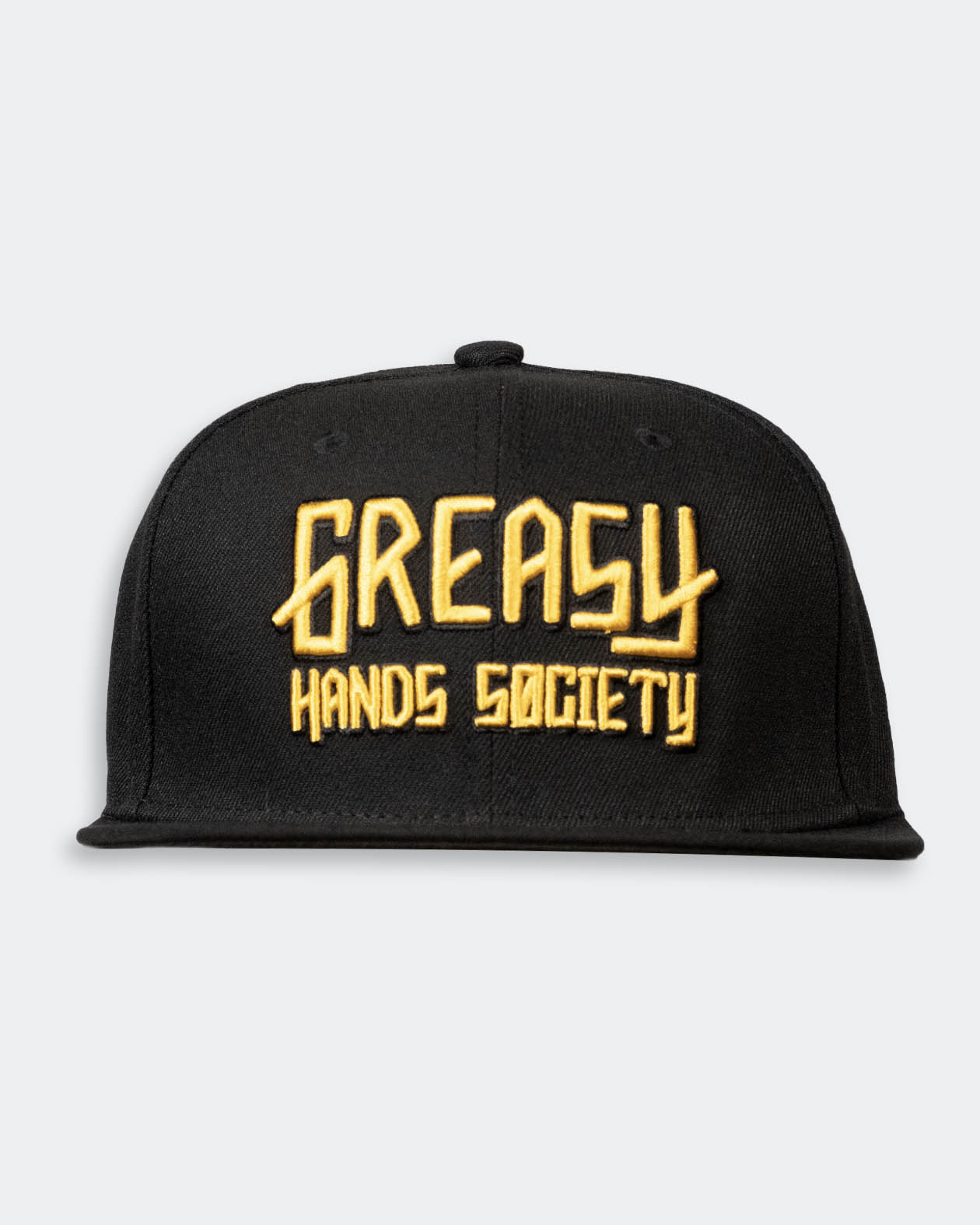 Black cap with gold 'Greasy Hands Society' logo on a light gray background
