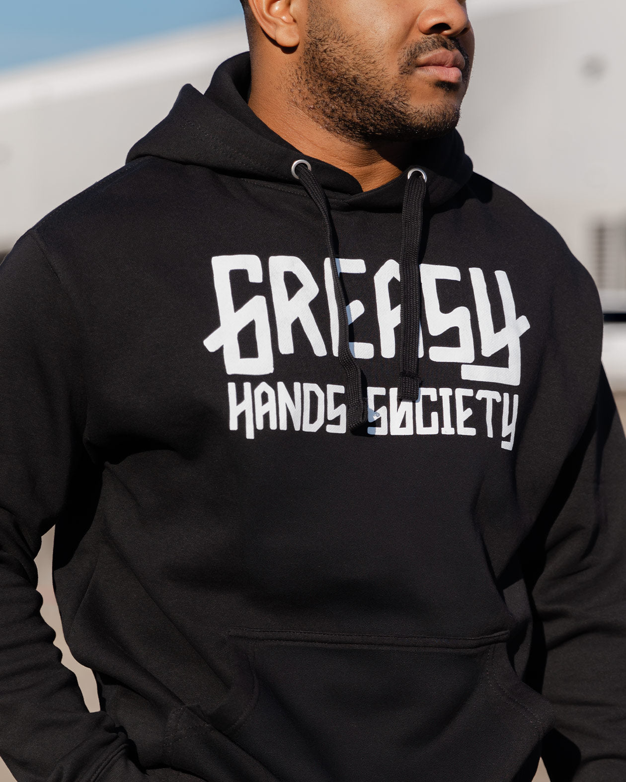 greasy hands society logo hoodie front on a model