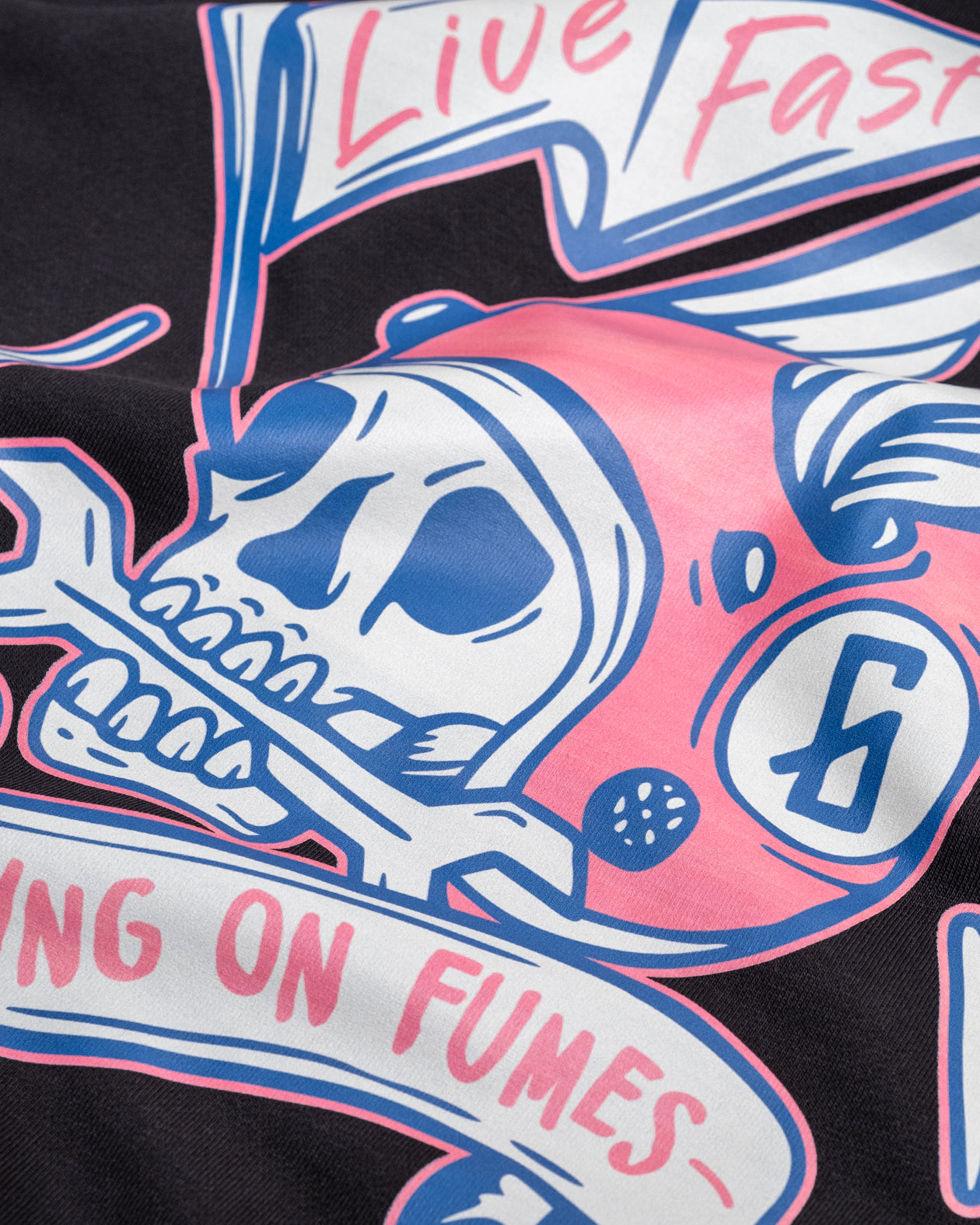 black hoodie back graphic detail with a skull with helmet and wings showing the words "Live Fast, running on fumes"