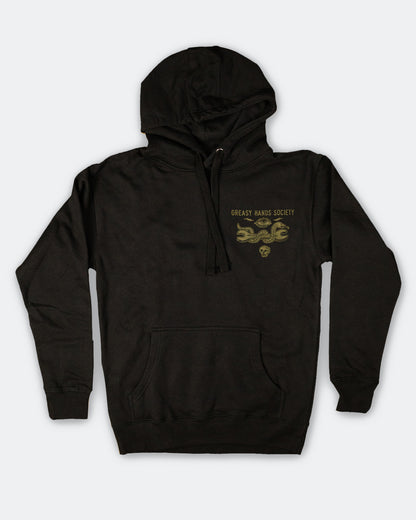 Black hoodie with gold greasy hands society text with a snake holding a wrench on the left chest on a white background - Snake Eye Hoodie by Greasy Hands Society