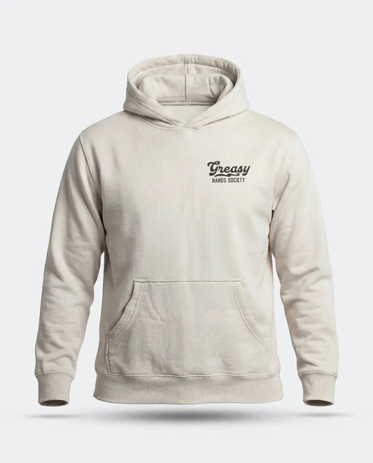 A light beige pullover hoodie with a small black 'Greasy Hands Society' logo on the left chest, displayed on a clean light gray background - Men's Destination Hoodie by Greasy Hands Society