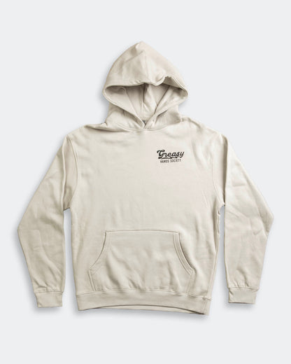 Beige hoodie called the destination hoodie for Men with a greasy hands society logo on a light gray background