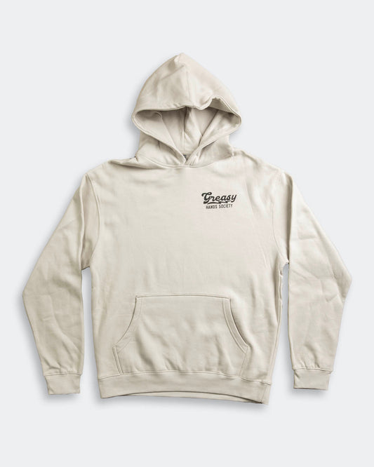 Beige hoodie called the destination hoodie for Men with a greasy hands society logo on a light gray background