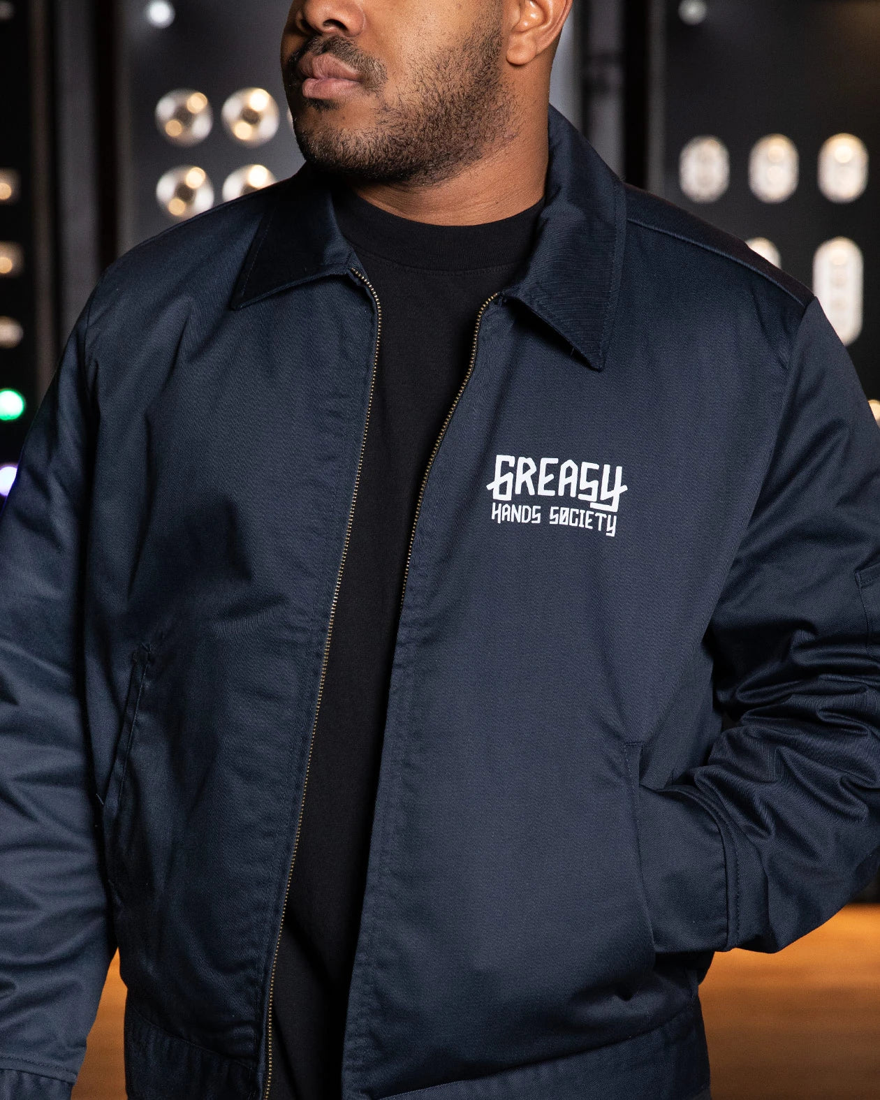 ghs blue logo mechanic jacket on a model