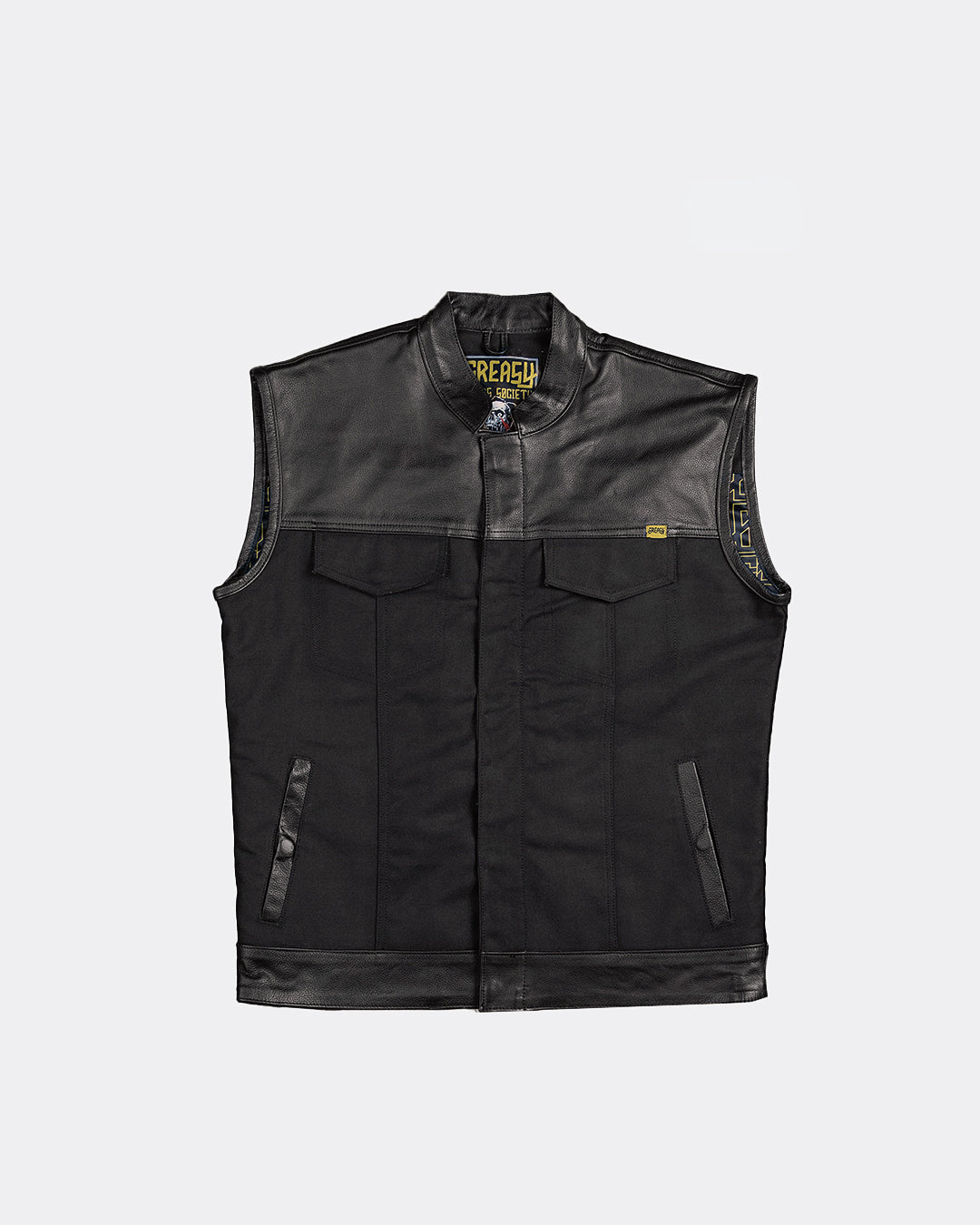 Black leather and canvas motorcycle vest with greasy hand society branding on a light gray background