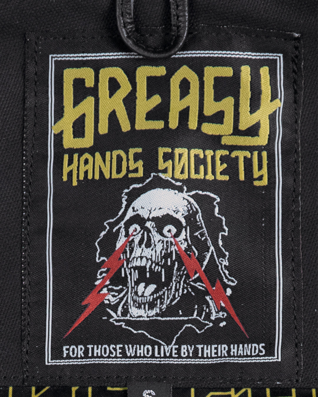 back patch on the jacinto leather/canvas vest with 'Greasy Hands Society' text and skull design on a black background