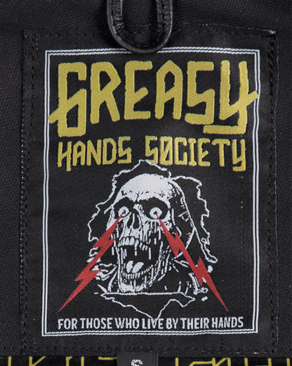 back patch on the jacinto leather/canvas vest with 'Greasy Hands Society' text and skull design on a black background