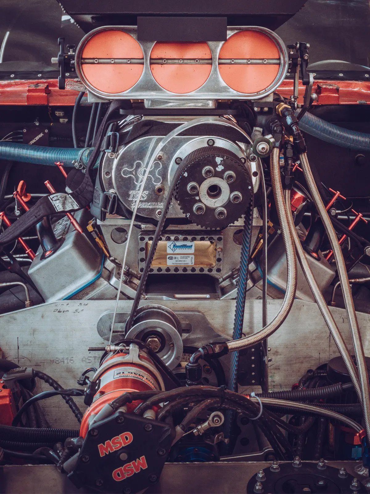 Close-up of a car engine with visible components and branding.