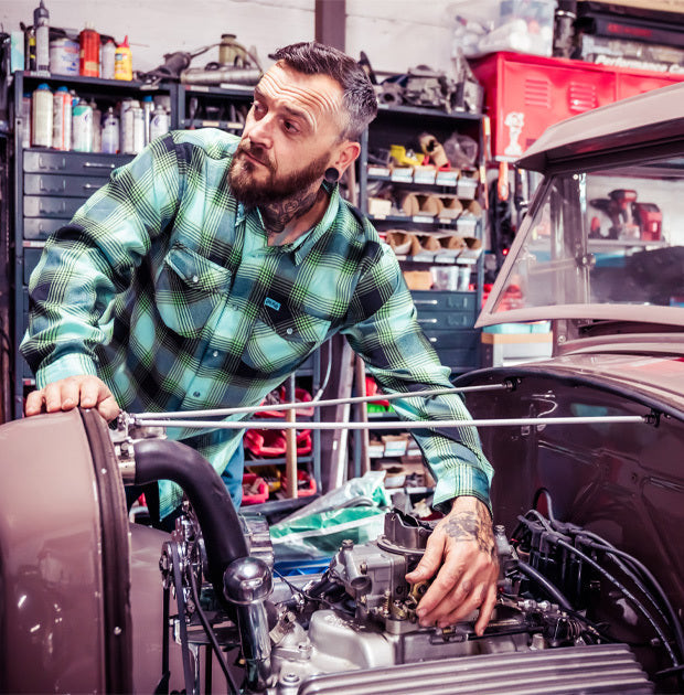 Man working on a car engine in a garage - Sucker Punch Flannel by Greasy Hands Society