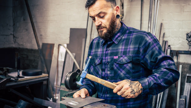 Man working with metal in a workshop - Kiss the Sky Flannel by Greasy Hands Society