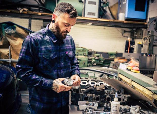 Man working on a car engine in a garage - Kiss the Sky Flannel by Greasy Hands Society