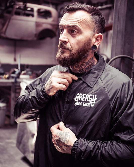 greasy hands society logo jacket front view on a model