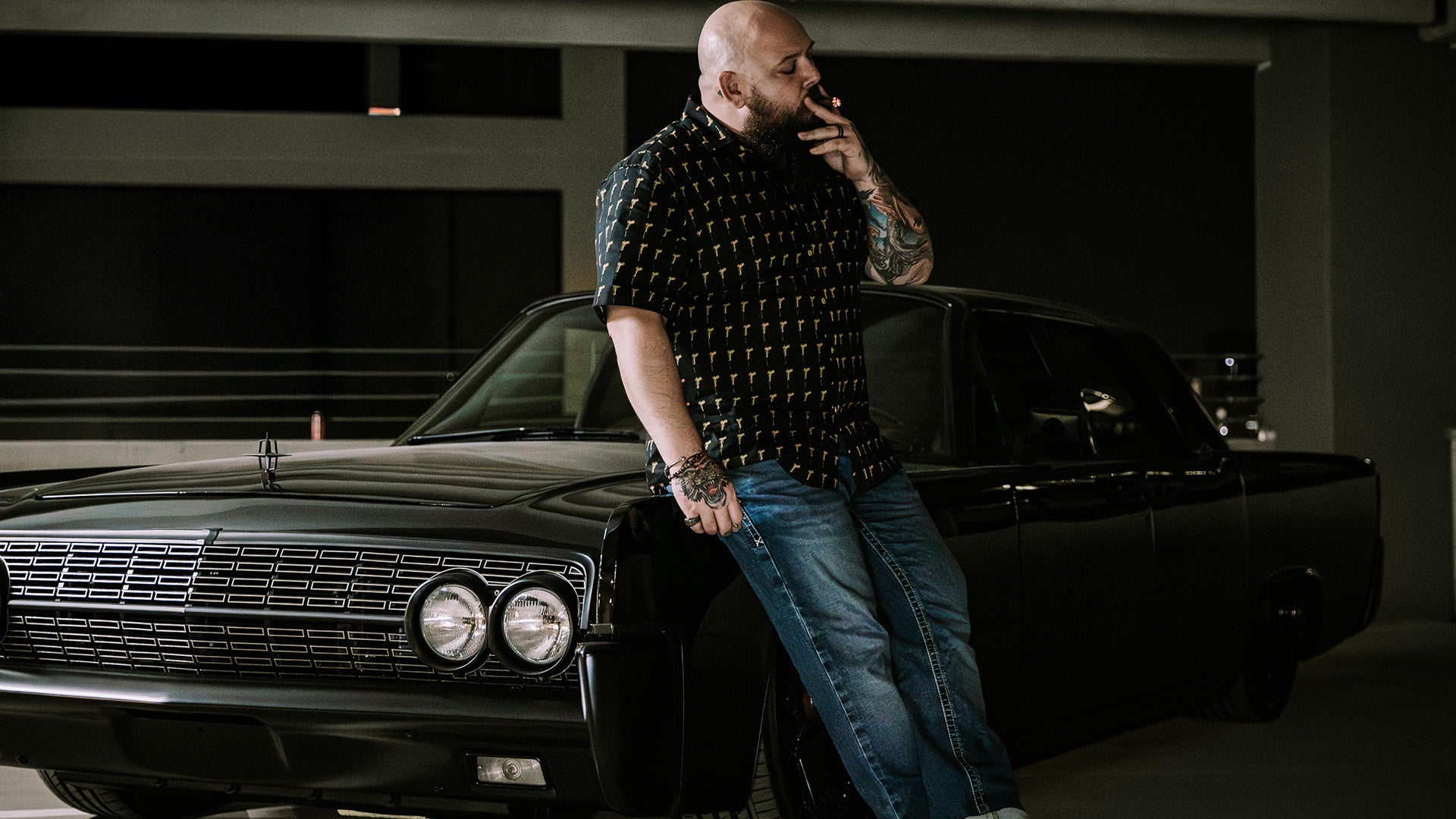 hitman black short sleeved button down with a golden gun pattern