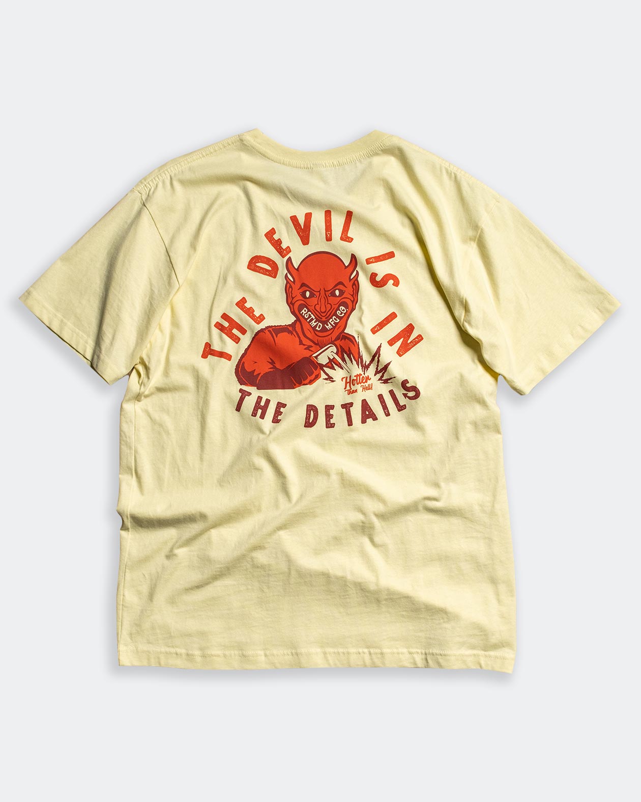 devil is in the details yellow tee shirt full back graphic of a devil flat lay